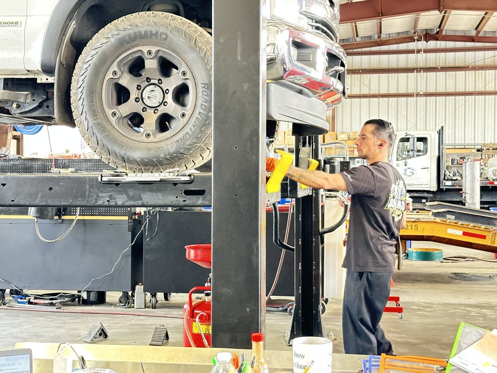 Technician working under a truck on a lift at Bonafide Truck and Equipment Repair, Cherry Valley, CA